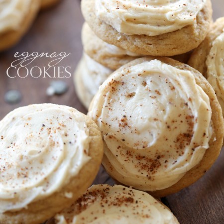 Eggnog Cookies stacked on a wooden board.