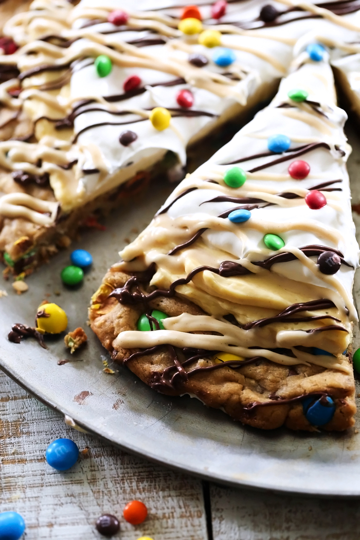 This M&M'S Monster Cookie Pizza is the ultimate dessert! It is layer upon layer of heaven! Everyone will be raving about this recipe! #BetterWithMMS @M&M'S Chocolate 