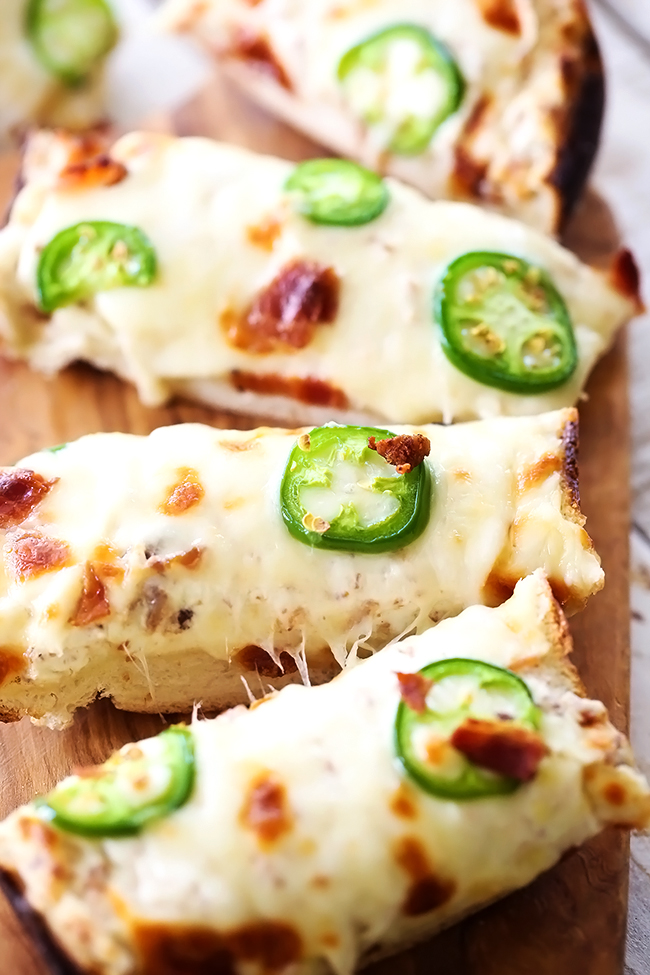 Cheesy Jalapeno Bacon Bread... This recipe is cheesy, flavorful and has a delicious kick of heat with a cream cheese spread to cool it down... it truly is INCREDIBLE and will be one of the most talked about appetizers!