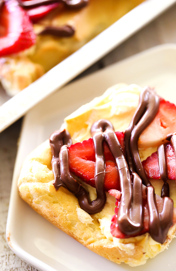 Strawberry Nutella Eclair Cake... this recipe is AMAZING and perfect for summer! The flavor and ingredient combo is divine!