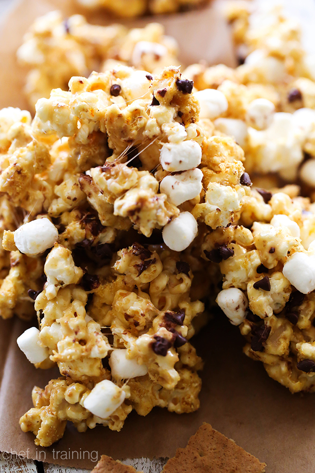 S'more Popcorn... This is coated in the most delicious ooey-gooey marshmallow-caramel and then garnished with graham cracker crumbs, mini chocolate chips and more mini marshmallows for the perfect finishing touch! It is one highly delicious and addictive snack!
