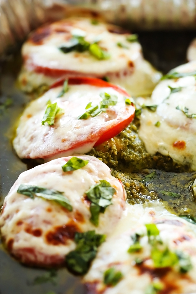 Pesto Chicken... This chicken is packed with flavor and super easy to make! With delicious pesto, melty cheese and tasty tomatoes, this is sure to be a hit at the dinner table!