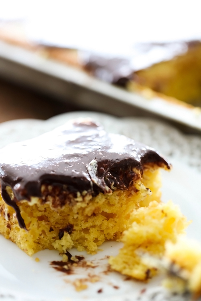 Boston Cream Pie Sheet Cake... A simple and delicious yellow cake with an incredible cream layer and smooth chocolate frosting to top it off! This serves a crowd and will be a huge hit wherever it goes!