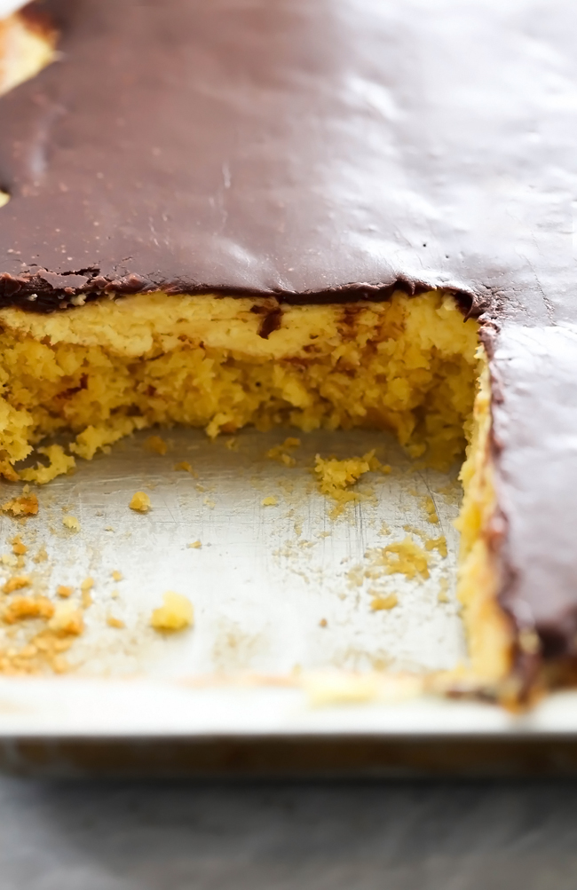 Boston Cream Pie Sheet Cake... A simple and delicious yellow cake with an incredible cream layer and smooth chocolate frosting to top it off! This serves a crowd and will be a huge hit wherever it goes!