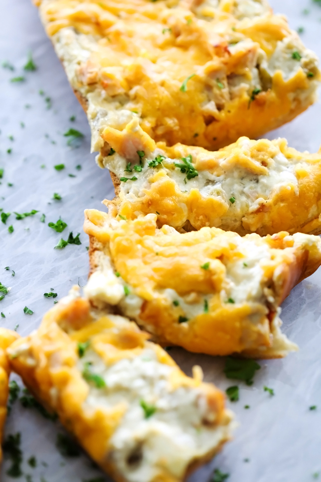 Green Chile Chicken French Bread... A delicious creamy and flavorful mixture spread over the top of french bread. It makes for an incredible crowd-pleasing appetizer!