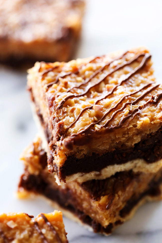 Layered Samoa Brownies... Layers of shortbread cookie, rich fudgy brownies and a delicious chewy coconut caramel topping. These brownies are textured with three different layers and will be a huge hit!