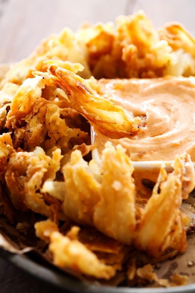 Blooming Onion with Dipping Sauce... This is such an incredible appetizer. The flavor of the battered onion combined with the sauce makes for one addictive and unforgettable recipe!