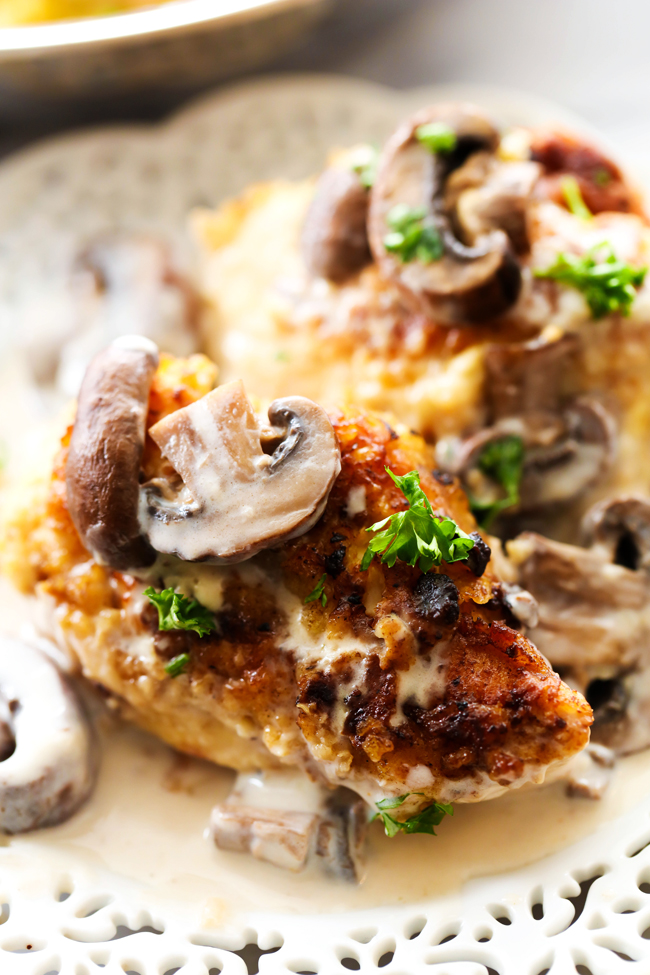 Pan-Fried Creamy Mushroom Chicken... A delicious battered chicken that is first pan-fried then baked and topped with a creamy mushroom gravy. This is a true restaurant quality dinner that will quickly become a new family favorite!