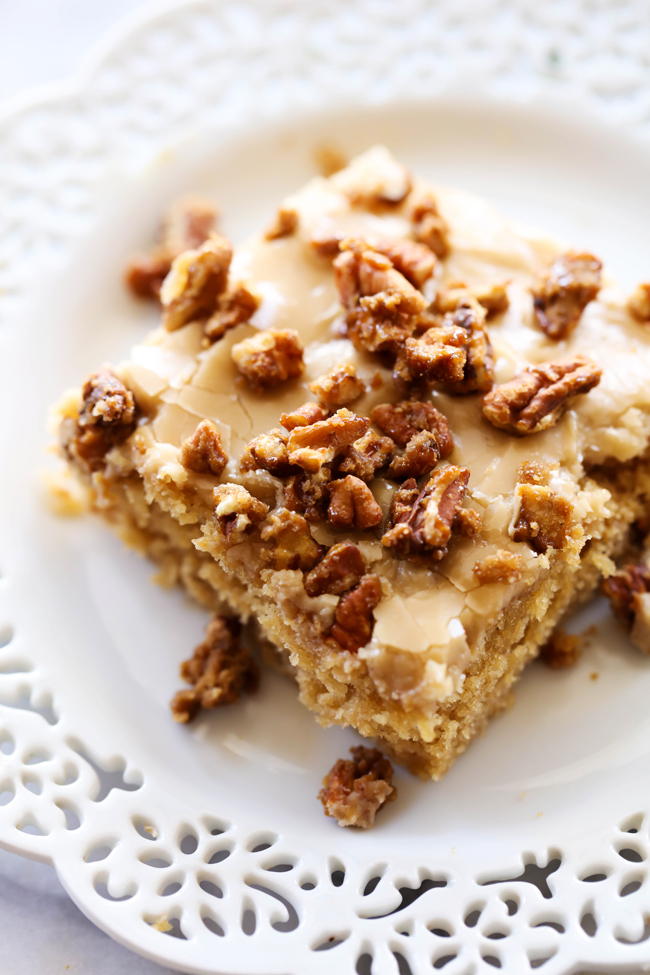 Praline Sheet Cake... A moist and delicious brown sugar sheet cake with an amazing caramel frosting. The sheet cake is topped wight he most delicious sweet and crunchy pralines for a perfect bite each and every time!