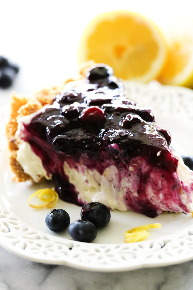 Lemon Blueberry Cream Pie... A delicious and fresh lemon cream pie in a homemade graham cracker crust and topped with the most delicious homemade blueberry sauce. This is a perfect summertime treat!