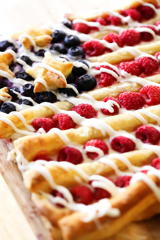 Patriotic Danish Pastry Dessert... not only does this resemble a festive flag, but will be one of the tastiest treats you ever make! The cream layer paired with the buttery puff pastry and fresh fruit combine for one heavenly dessert!
