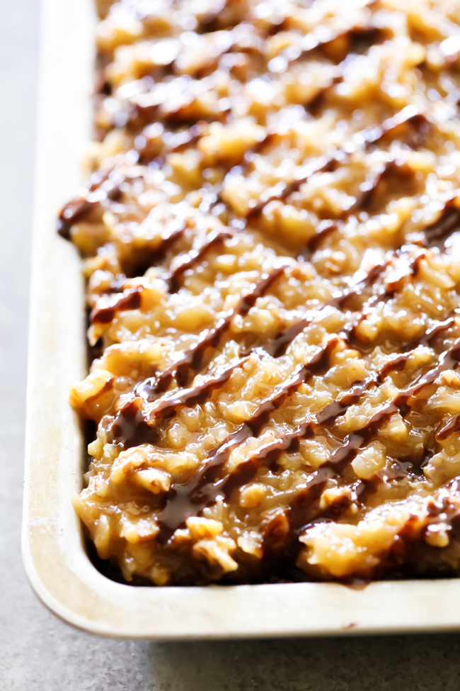 This German Chocolate Sheet Cake is so moist and SO delicious! The Coconut Pecan Frosting on top adds a richness and flavor that will blow you mind! This recipe is perfect for feeding a crowd!