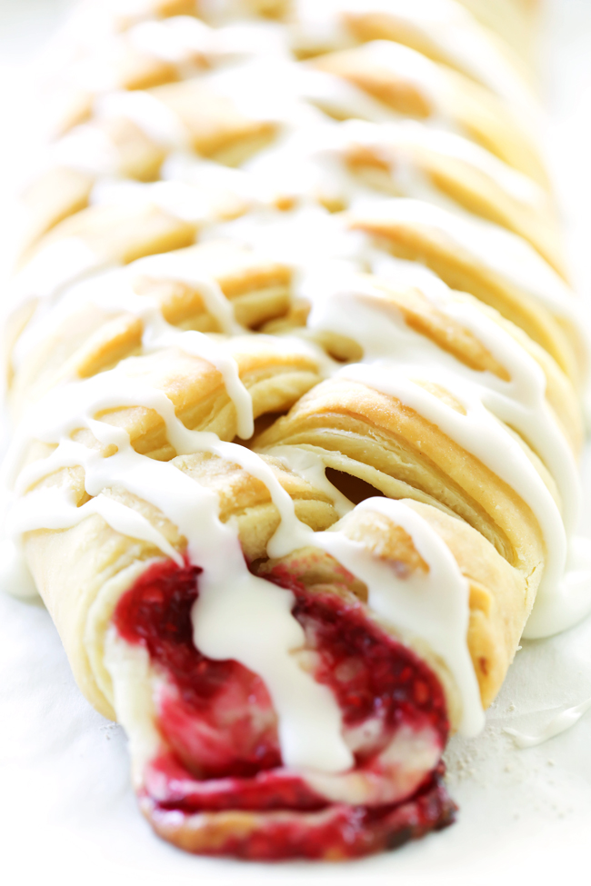 This Raspberry Cream Cheese Danish Braid is SO simple and tastes incredible! The puff pastry just melts in your mouth and is perfectly paired with a cream cheese filling and a delicious raspberry sauce.