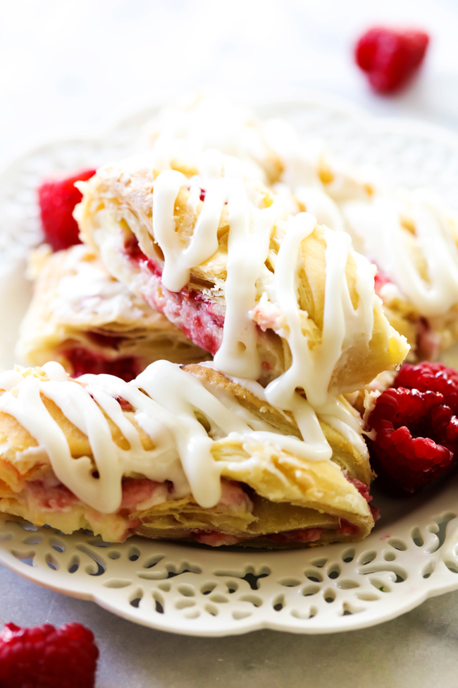 This Raspberry Cream Cheese Danish Braid is SO simple and tastes incredible! The puff pastry just melts in your mouth and is perfectly paired with a cream cheese filling and a delicious raspberry sauce.
