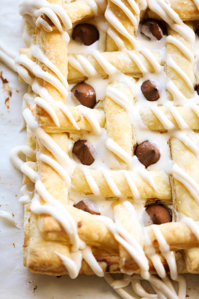 This HERSHEY'S KISSES Cream Cheese Pastry consists of buttery flaky puff pastry, a delicious cream cheese filling, is topped with HERSHEY'S KISSES Chocolates and drizzled with a creamy glaze. This dessert whips up in no time at all and tastes incredible! #sponsored HERSHEY'S Chocolate