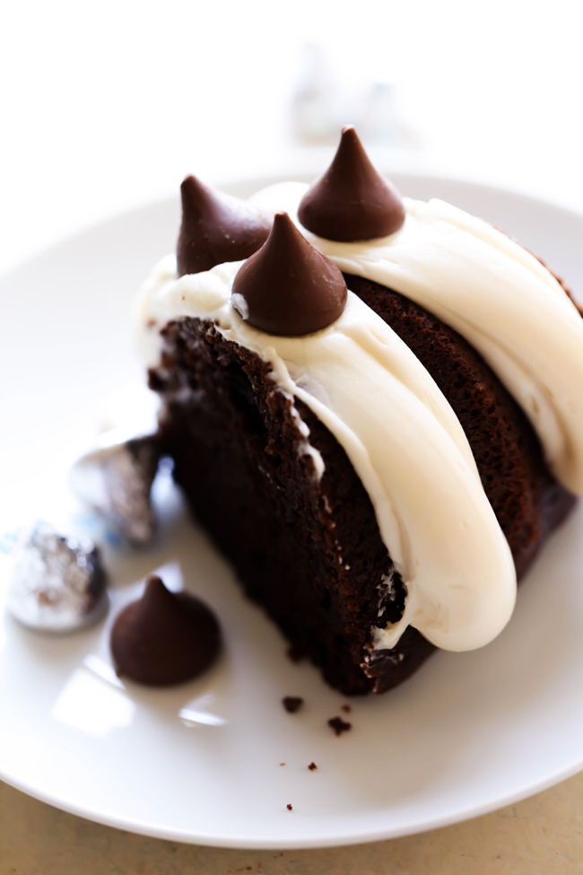 This HERSHEY’S KISSES Bundt Cake is an extremely moist cake loaded with KISSES Chocolates inside. It is finished off with a thick cream cheese frosting which compliments the flavor perfectly! #sponsored HERSHEY’S Chocolate