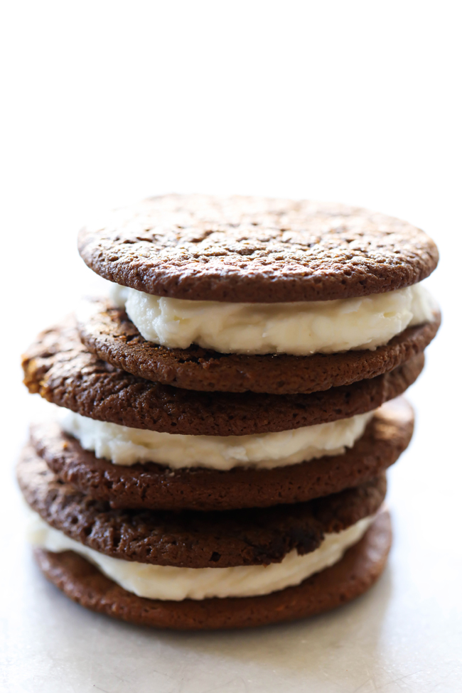 Gingerbread and Cream Cookie Sandwiches... a delicious chewy gingerbread cookie with a wonderful creamy frosting. The flavor combination is perfection. They make a wonderful holiday treat!