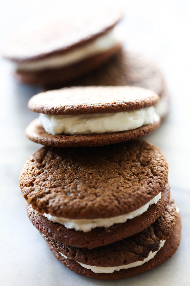 Gingerbread and Cream Cookie Sandwiches... a delicious chewy gingerbread cookie with a wonderful creamy frosting. The flavor combination is perfection. They make a wonderful holiday treat!