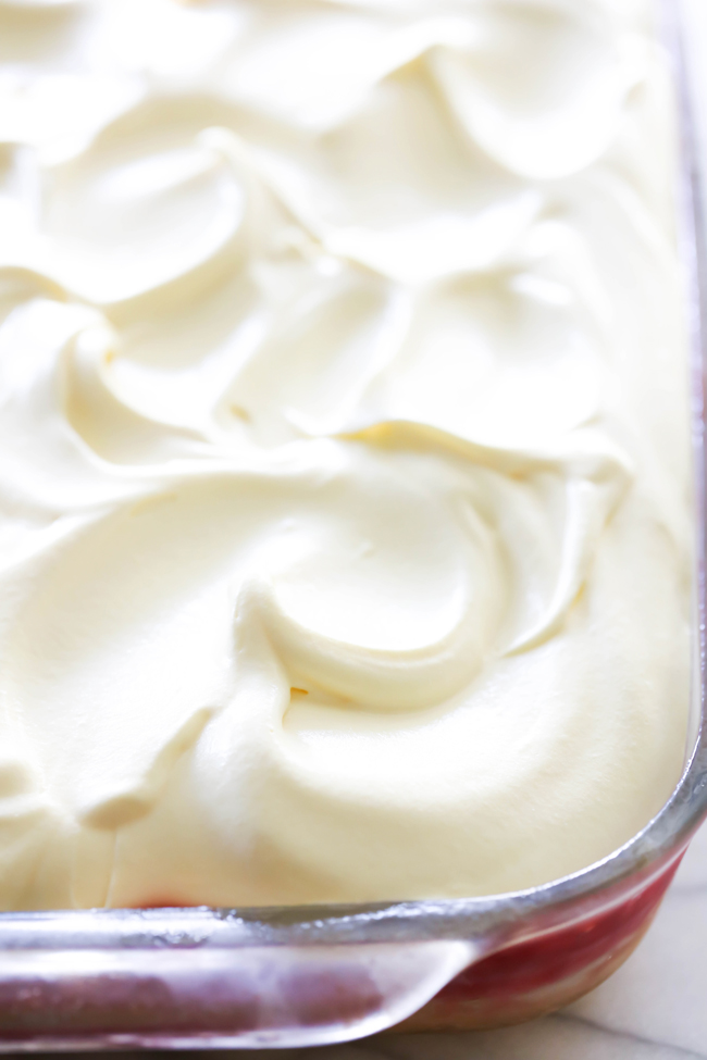 This Raspberry Poke Cake is so simple and such a wonderful dessert! It has a wonderful berry filling infused into each bite of cake that is both tart and sweet.