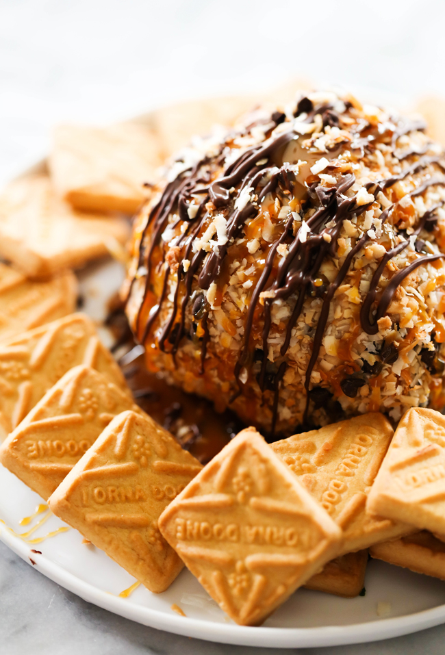 This Samoa Cheese Ball is loaded with caramel, chocolate and coconut and is such a delightful sweet treat! It is served with shortbread cookies and is great for any party or get together!