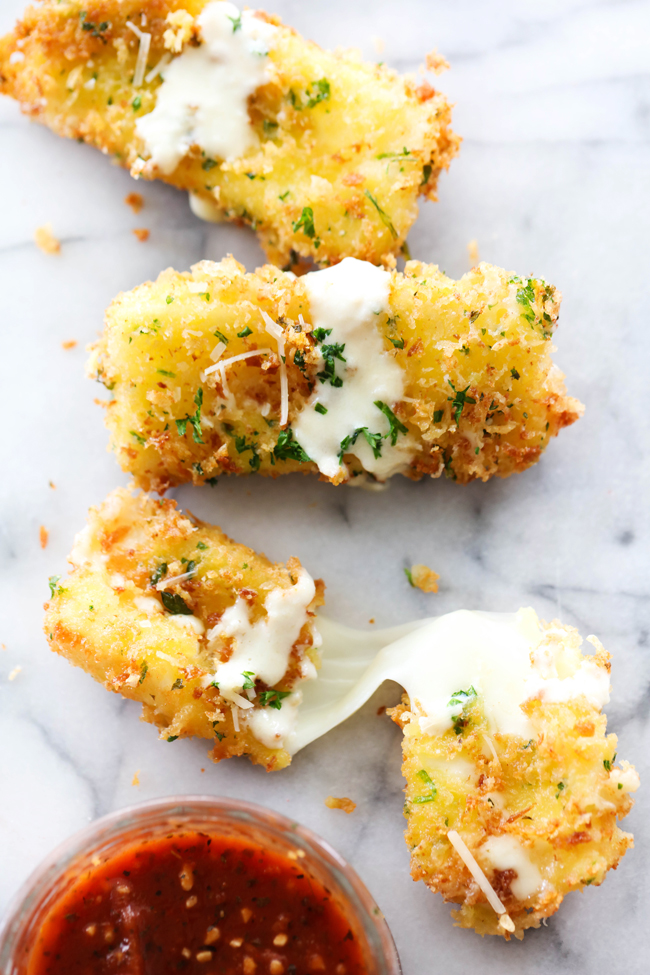 This Fried Mozzarella is simple, delicious and a perfect appetizer. The outside is crispy with a gooey soft cheesy inside. It is drizzled with Alfredo and paired with Marinara. The flavor combo makes this one outrageously tasty party food!