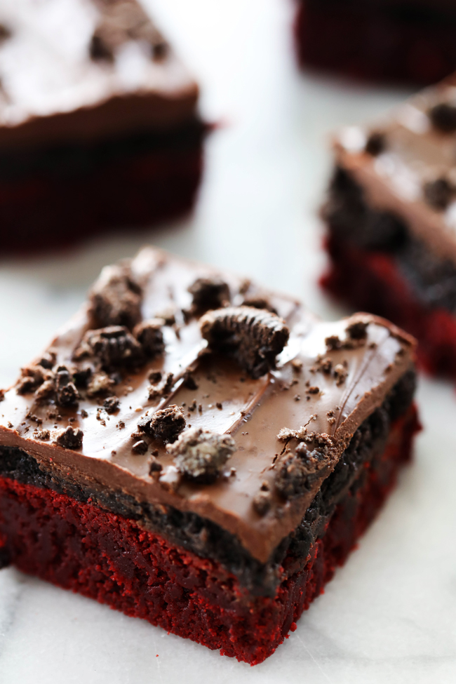 These Red Velvet Oreo Truffle Brownies are fantastic! Fudgy red velvet brownies, delicious Oreo truffle and melted chocolate combine to make the three layers of this spectacular dessert. They are a hit with everyone who try them!