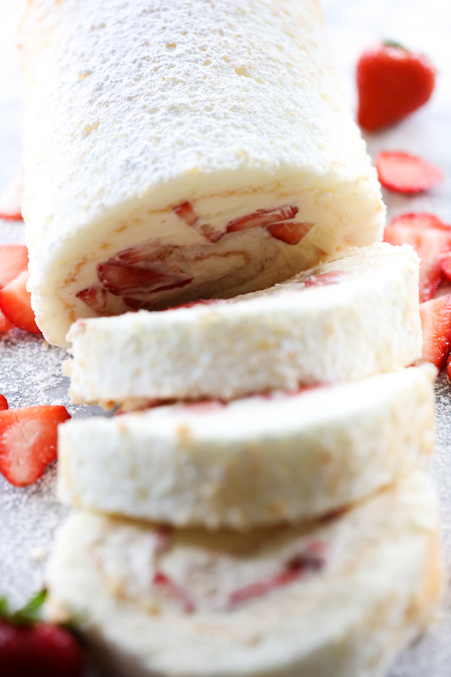 This Strawberry Shortcake Cream Roll is light, refreshing and the perfect treat to indulge in! It begins with an angel food cake that is filled with cream and strawberries. This will be the hit of any gathering!