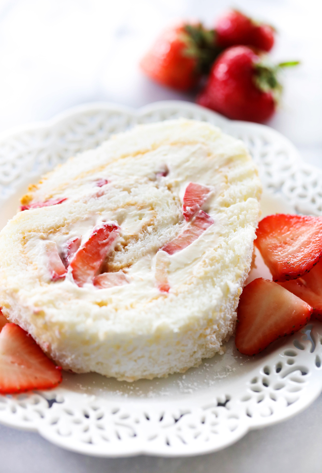 This Strawberry Shortcake Cream Roll is light, refreshing and the perfect treat to indulge in! It begins with an angel food cake that is filled with cream and strawberries. This will be the hit of any gathering!