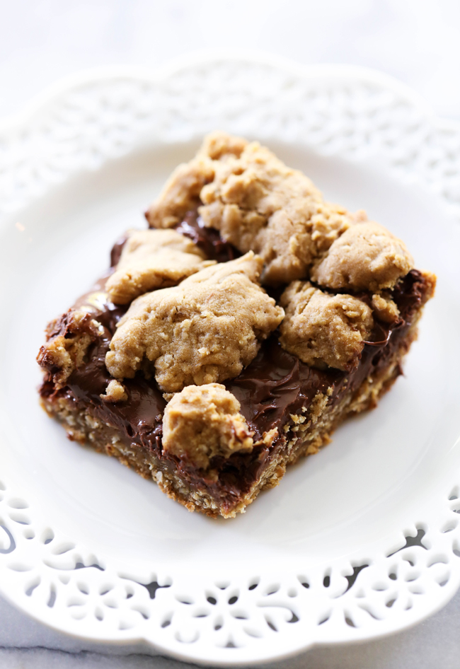 These Nutella Oatmeal Cookie Bars are chewy, gooey and absolutely amazing! They are a perfect easy dessert that is a hit with all who try it! The oatmeal cookie base and topping pair perfectly with the Nutella layer.