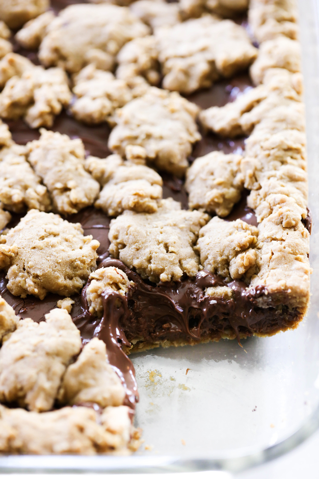 These Nutella Oatmeal Cookie Bars are chewy, gooey and absolutely amazing! They are a perfect easy dessert that is a hit with all who try it! The oatmeal cookie base and topping pair perfectly with the Nutella layer.