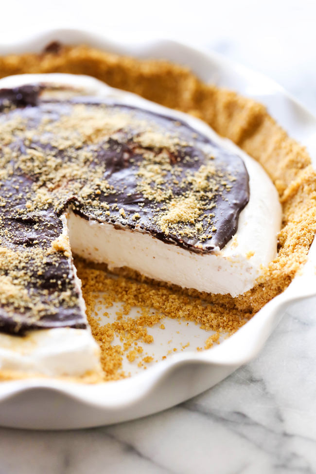 This S'more Pie begins with a delicious homemade graham cracker crust. It is filled with a divine marshmallow cream filling and topped with a rich chocolate ganache. This is such a fun and unique way to enjoy all the wonderful flavor of s'mores without having to leave your house!
