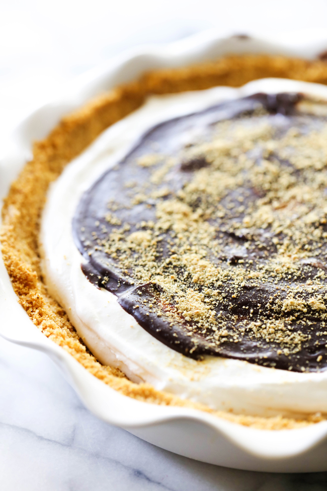 This S'more Pie begins with a delicious homemade graham cracker crust. It is filled with a divine marshmallow cream filling and topped with a rich chocolate ganache. This is such a fun and unique way to enjoy all the wonderful flavor of s'mores without having to leave your house!
