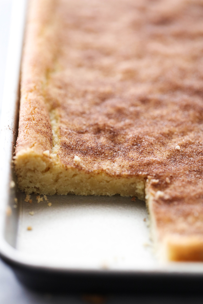 These Snickerdoodle Cookie Bars are outstanding. No more rolling each ball of dough individually- this recipe turns a time consuming recipe into an easy, quick method. Enjoy the delicious snickerdoodles in bar form. A delicious blend of cinnamon-sugar coat the top of the moist and soft cookie bars. This will be a recipe you want to make over and over again!
