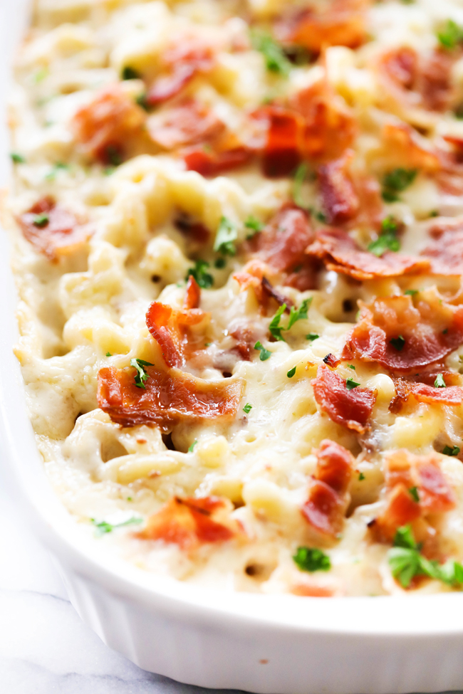 Garlic Pepper Jack Mac and Cheese in a white casserole dish garnished with crumbled bacon.