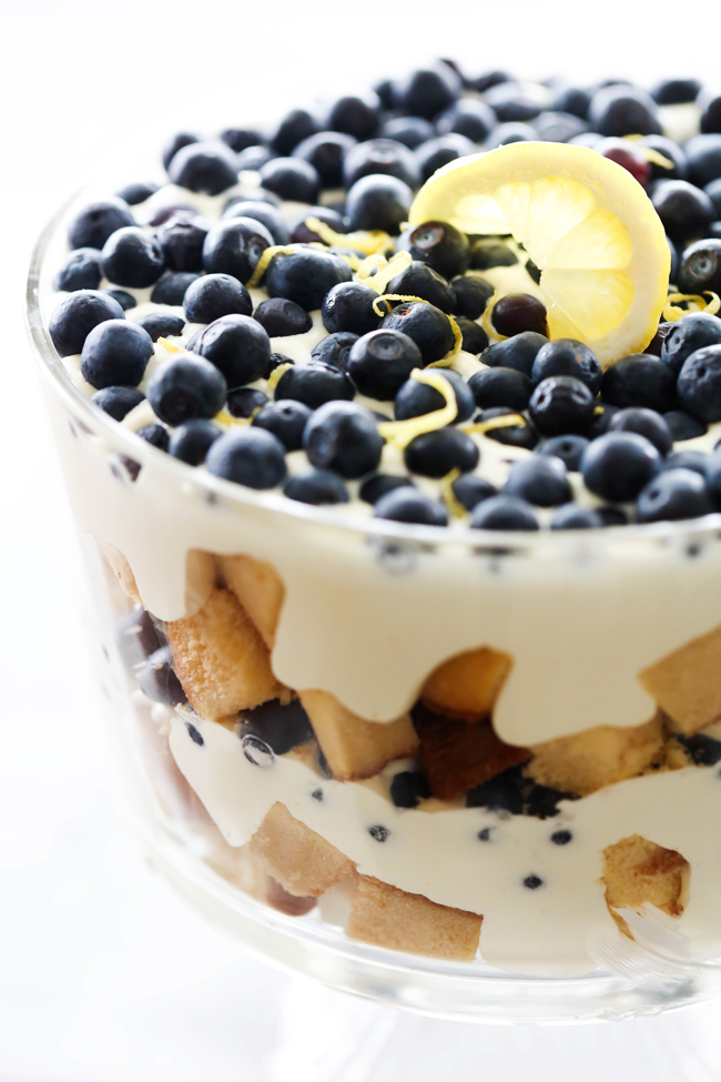 Lemon Blueberry Trifle in a clear trifle bowl to display layers of cream, cake and fruit.