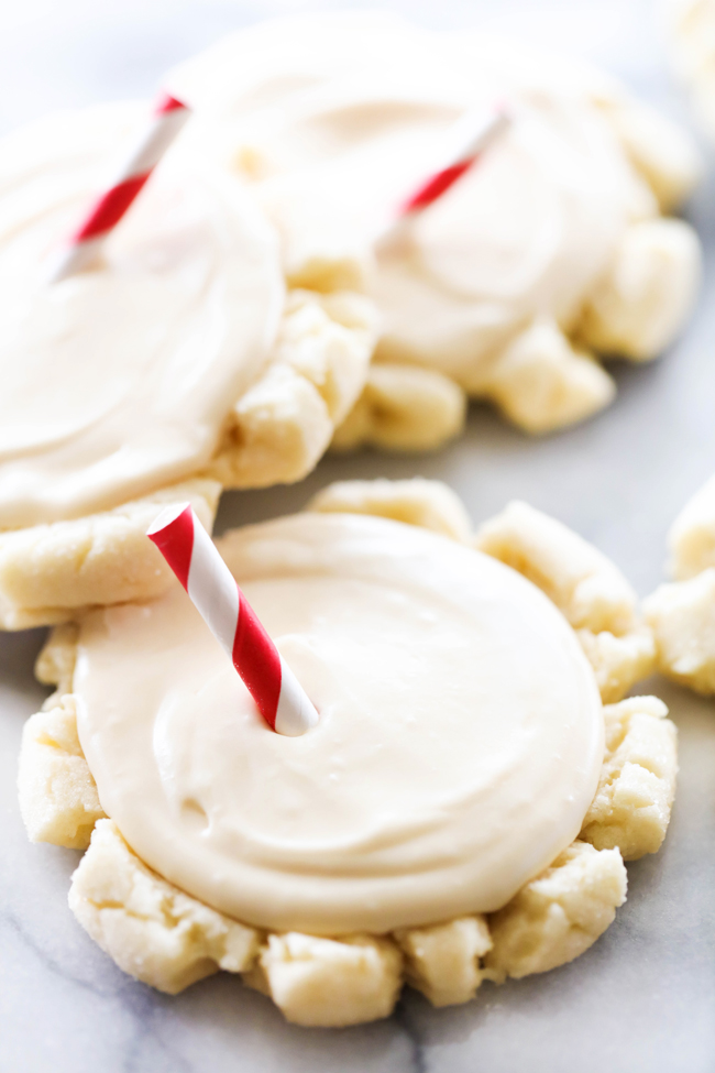 Root Beer Float Sugar Cookies with decorative red and white striped straw in center of cookies.