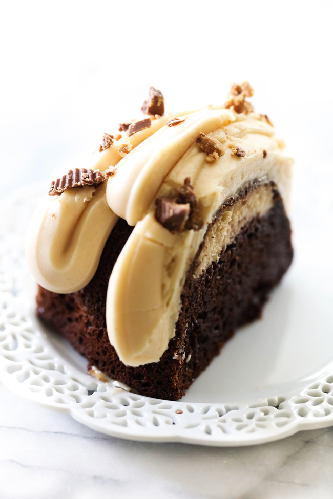 Slice of Chocolate Peanut Butter Cheesecake Bundt Cake garnished with chopped peanut butter cup candy on a white plate.