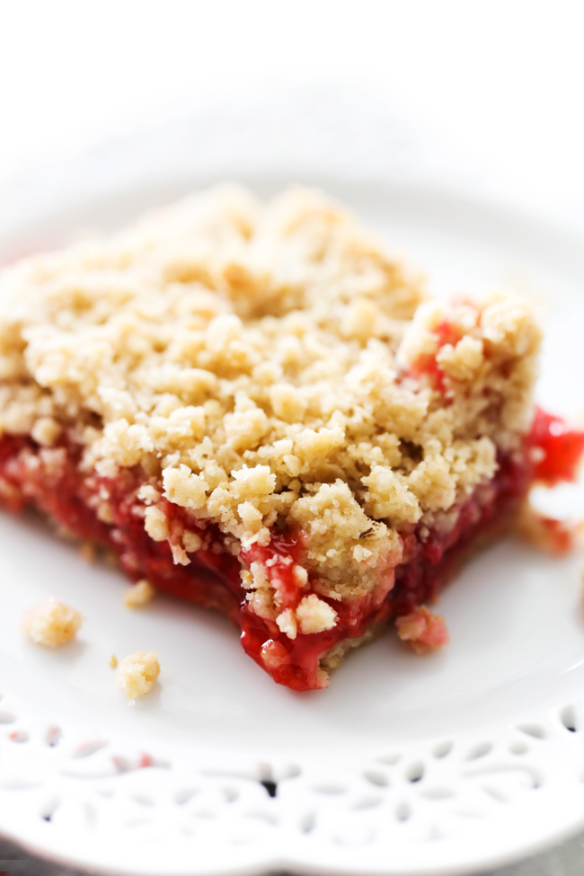 Serving of Raspberry Crumble Bars on a white plate.