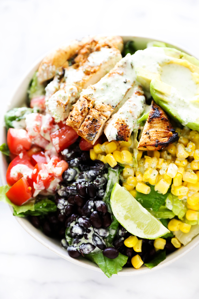 Southwest Chicken Salad drizzled with Creamy Tomatillo dressing in a white bowl.