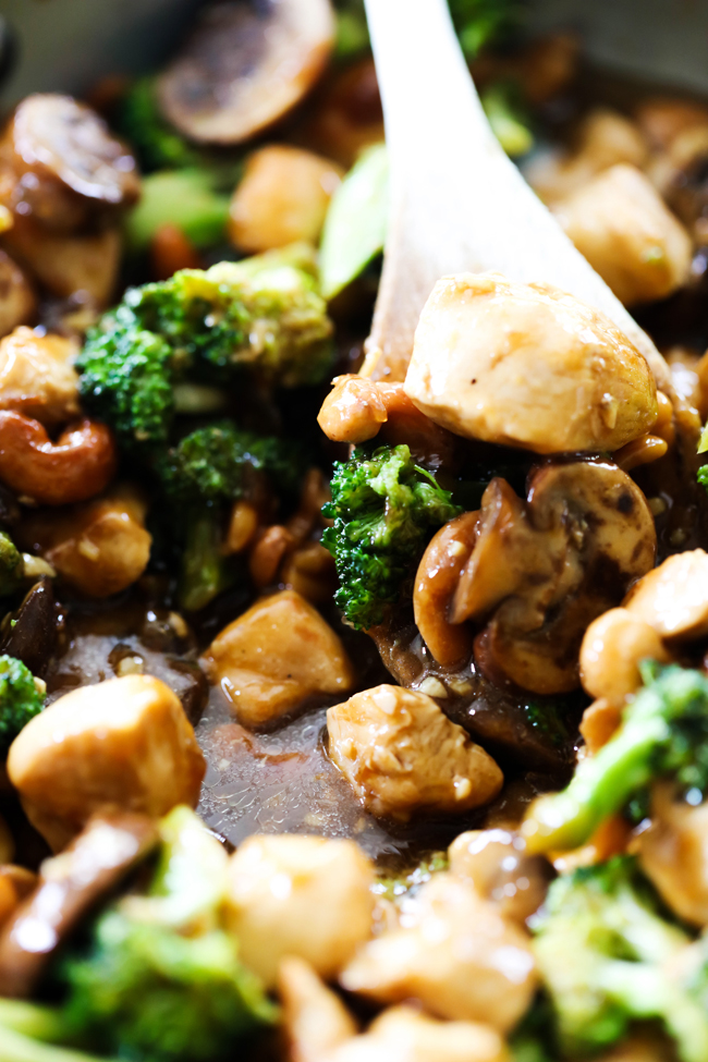 Chicken Broccoli Stir Fry in skillet with wooden spoon.