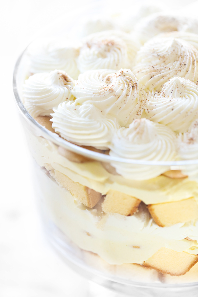 Eggnog Trifle displayed in a clear trifle dish to reveal the layers of cream, cake and whipped topping.