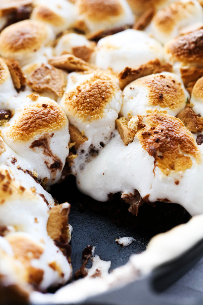 Skillet S'more Brownie cut into with melting marshmallows.