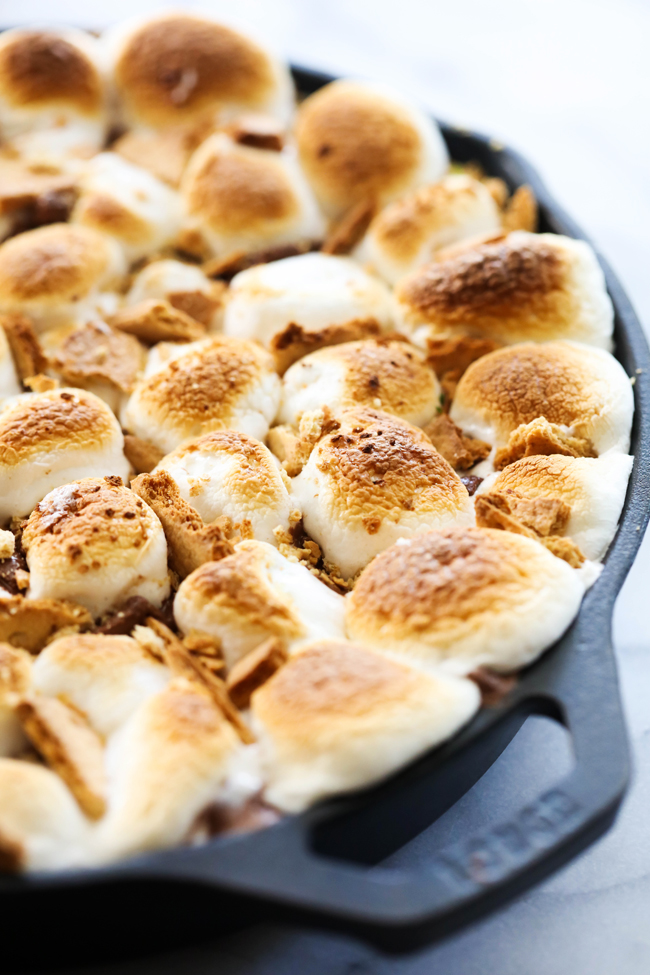 Skillet S'more Brownie with toasted marshmallows in a cast iron skillet.