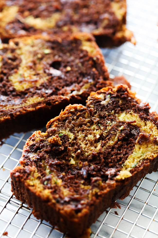 Slices of Chocolate Swirl Banana Zucchini Bread on a cooling rack.