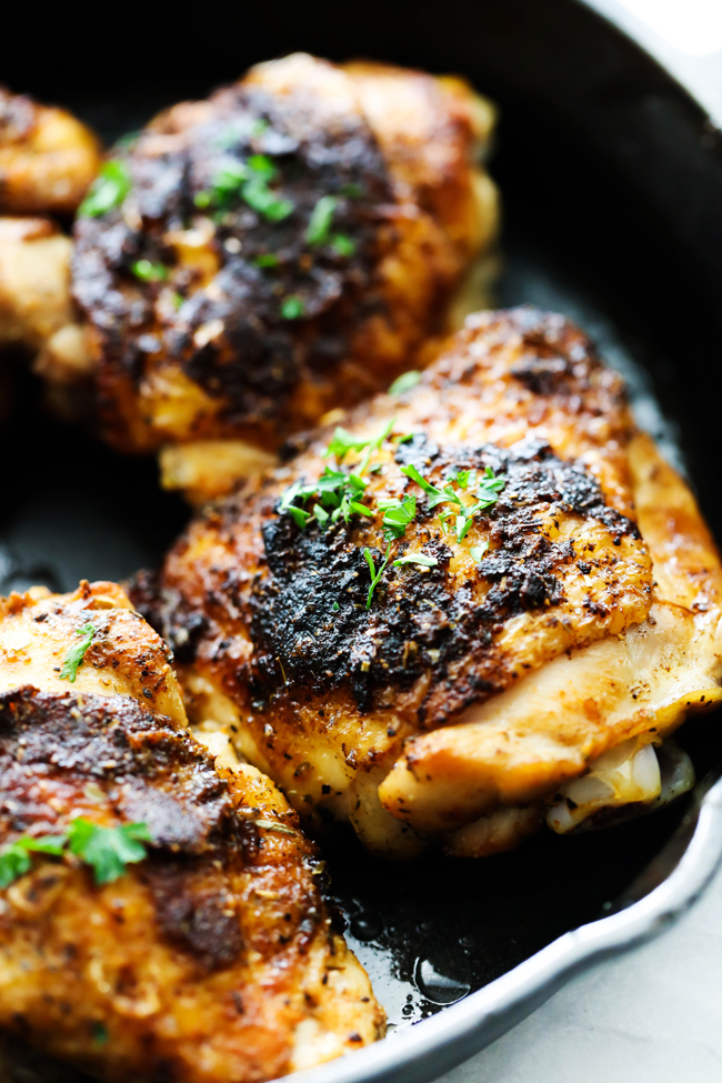 Italian Herb Chicken Thighs in a cast iron skillet.