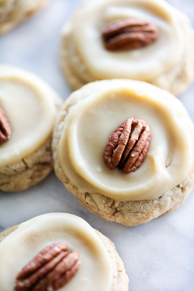 Arial view of Pecan Cookies topped with Caramel Icing and a pecan.